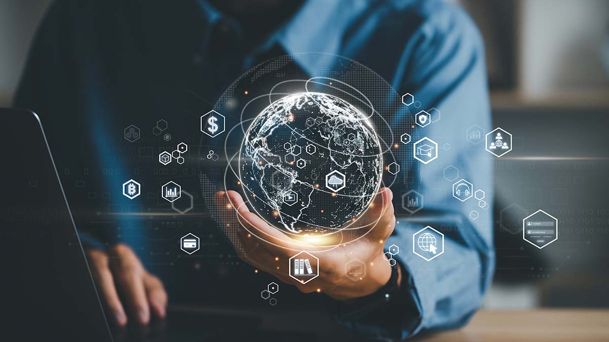 Man holding a virtual globe with different technology icons