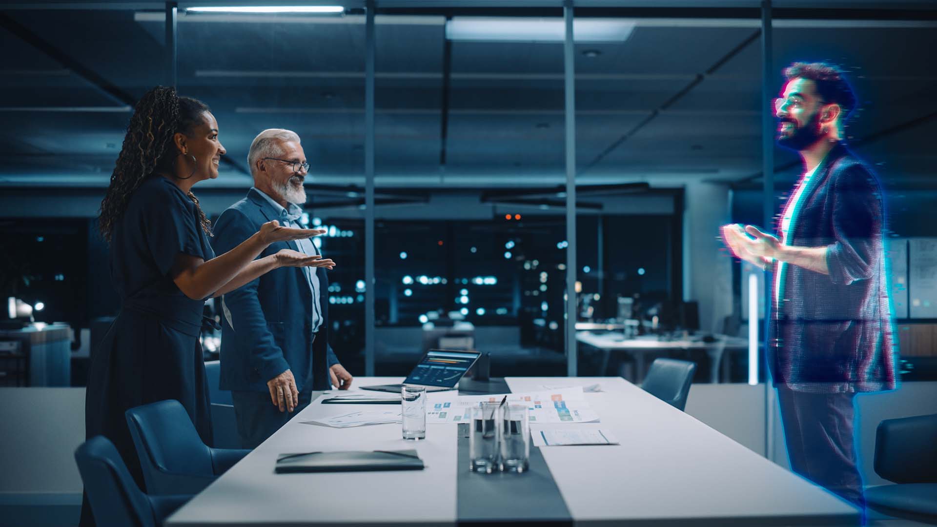 A group of in office employees interacting with a remote virtual hologram employee
